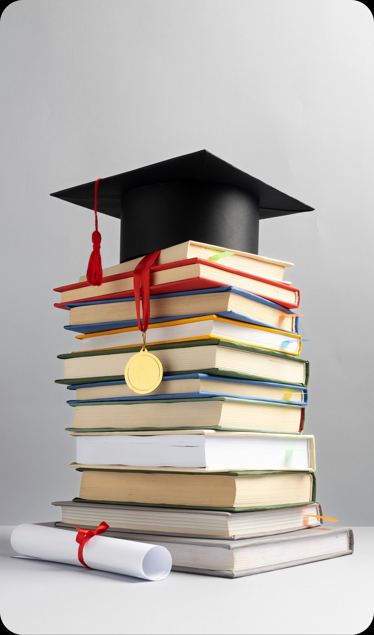 Books, graduation cap, medal, and diploma